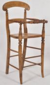 A late victorian beech wood childs pine high chair Turned legs united by stretchers having