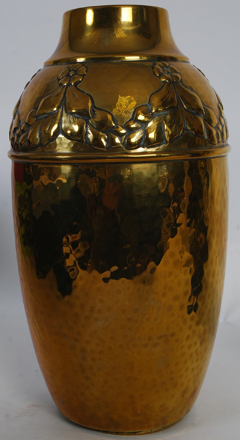 A WMF brass aesthetic movement german handbeaten vase of baluster form having flower and vine