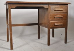A 1940's Air Ministry oak clerks desk. A bank of drawers to one side with open kneehole, all under