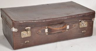 A vintage 20th century crocodile skin suitcase having clasp locks to the front