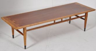 An American 1970's  retro teak wood Danish influence coffee table. Raised on turned legs with