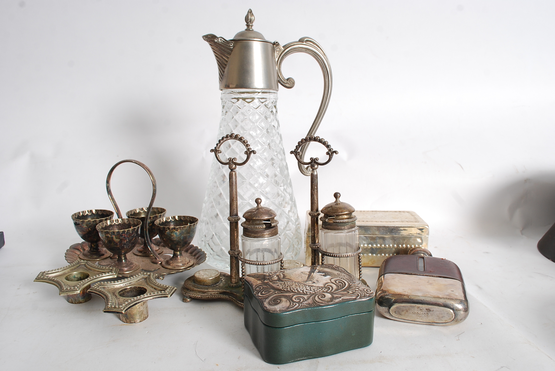 A collection of silver plated items to include cut glass decanter, , condiment sest. candlesticks,