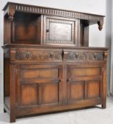 A Jacobean revival oak court cupboard. The base having double door cupboard with short drawers