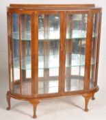 A good 1930's Art Deco walnut display cabinet. Raised on cabriole legs with pad feet supporting a