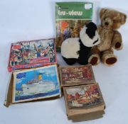 A collection of vintage toys to include jigsaw puzzles ( including Victory ) and 2 vintage musical
