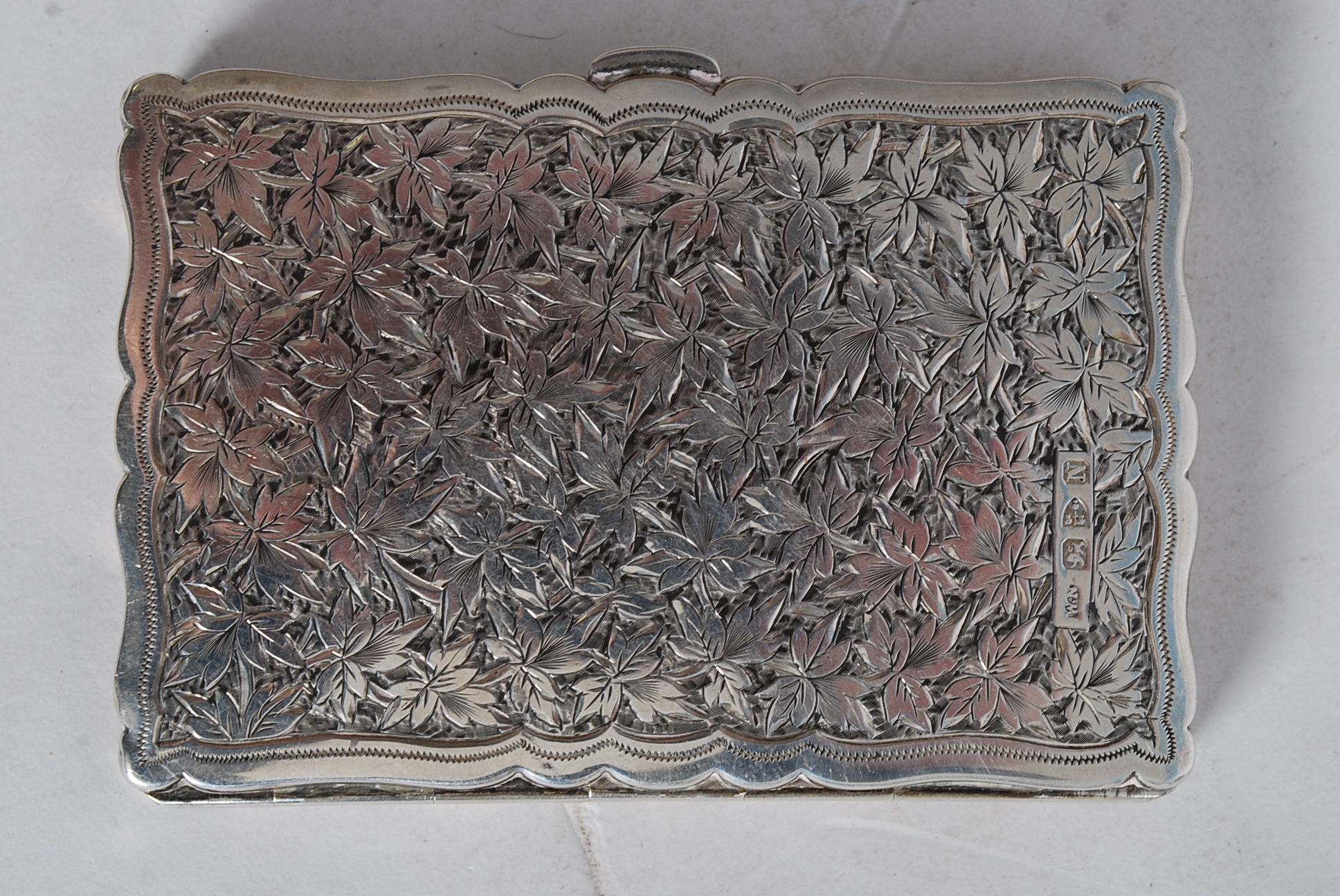 A William Neale Chester hallmarked rococo chase decorated card holder dating to 1896. The interior