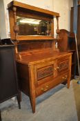 An Edwardian oak sideboard / dresser. Raised on turned legs with cupboards to base having a tall