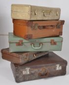 A stack of vintage suitcases / trunks to include leather, green, brown and cream examples ( 5 in