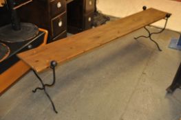 An unusual cast metal and wooden hall bench. Decorative rococo supports with wooden slat top