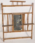 A Victorian bamboo wall mirror having breakfrotn shelves surrounding the central mirror