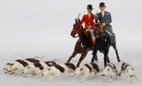 A Britains painted lead toy hunting set to include 2 mounted horses and hound pack.