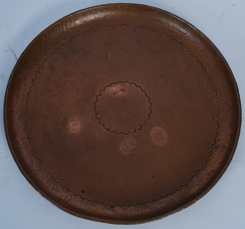 A Newlyn of Cornwall copper charger tray. Circular form having scalloped decoration, stamped