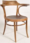 A 1920's bentwood armchair in the manner of Thonet. Turned legs united by peripheral stretchers with
