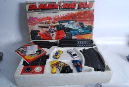 A vintage Scalextric 500 toy car racing game, in original box including two cars, track, controllers
