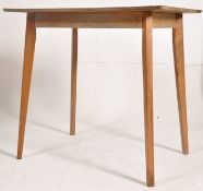 A 1950's retro turquoise formica and beech wood kitchen dining table. Raised on tapered legs with