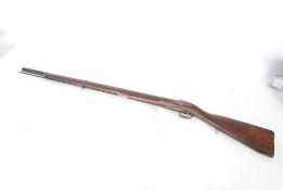 A 19th century military issue British Anglo - Indian musket with elm stock. The unrifled barrel