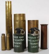 A selection of brass shells along with two training smoke grenades