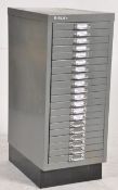 A small grey retro 1970's steel grey filing cabinet of multiple drawers with handles and notation