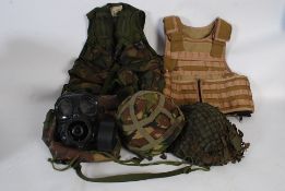 A good selection of contemporary military items of clothing to include helmets, vests, respirator