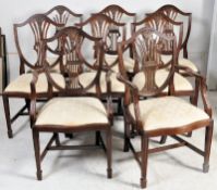 A set of 8 mahogany hepplewhite dining chairs. Square tapered legs with spade feet united by