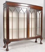 A 1930's Queen Anne revival mahogany bow fronted display cabinet with claw and ball feet having