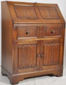 A good Jaycee oak writing desk bureau in the Jacobean style. The base with cupboard and  short