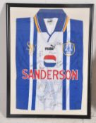 A framed and glazed signed Sheffield  Wednesday football shirt circa 1990's. Meaures 62 x 42cms