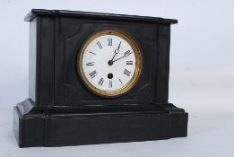 A 19th century slate mantel clock having an enamel face with glass cover. the brass movement set