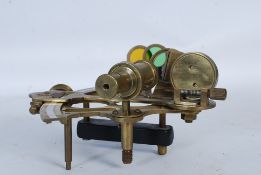 A 20th century brass sextant raised over ebonised plinth with coloured lenses