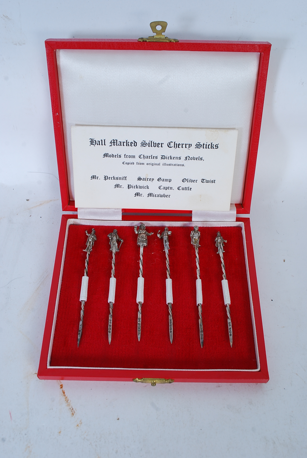 Set of six hallmarked silver cherry sticks, the handles with models from Charles Dickens` novels,