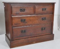 An Edwardian walnut cottage chest of drawers. 2 short drawers over 2 deep drawers beneath. Raised on