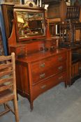 An Edwardian mahogany dressing table chest of drawers. Raised on turned legs with a series of