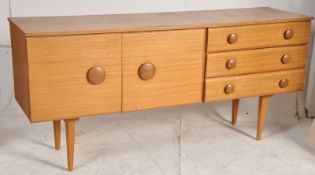 A retro teak veneer 1970's low sideboard. Raised on turned supports having a series of cupboards and