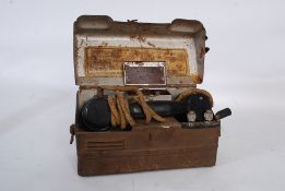 A vintage military issue / engineers field telephone complete in the tin case having paper
