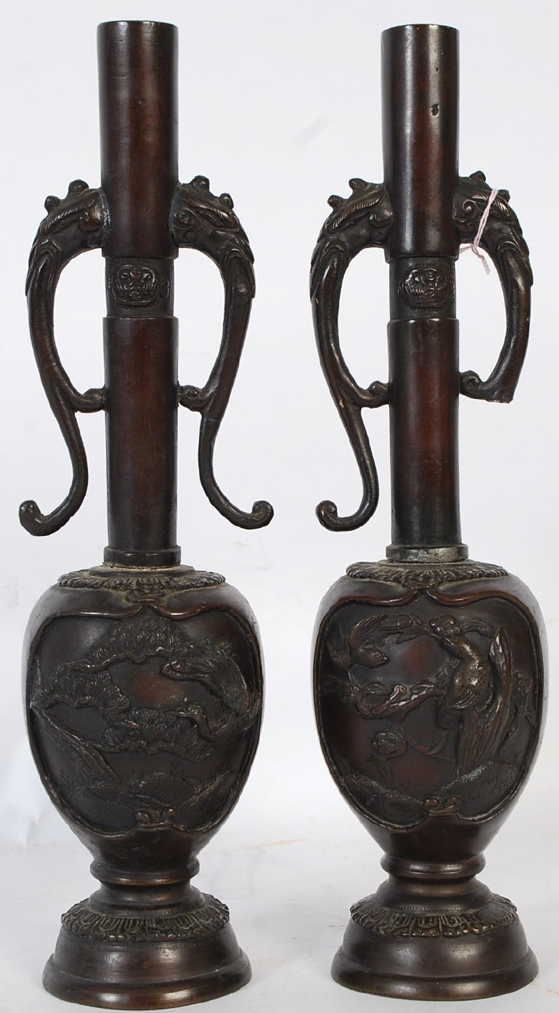 A pair of Japanese twin handled bronze vases, Meiji period, tall neck with bird headed handles