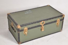 A green contemporary steamer trunk with hinged lid and brass bindings. H 37cm W 92cm D 53cm