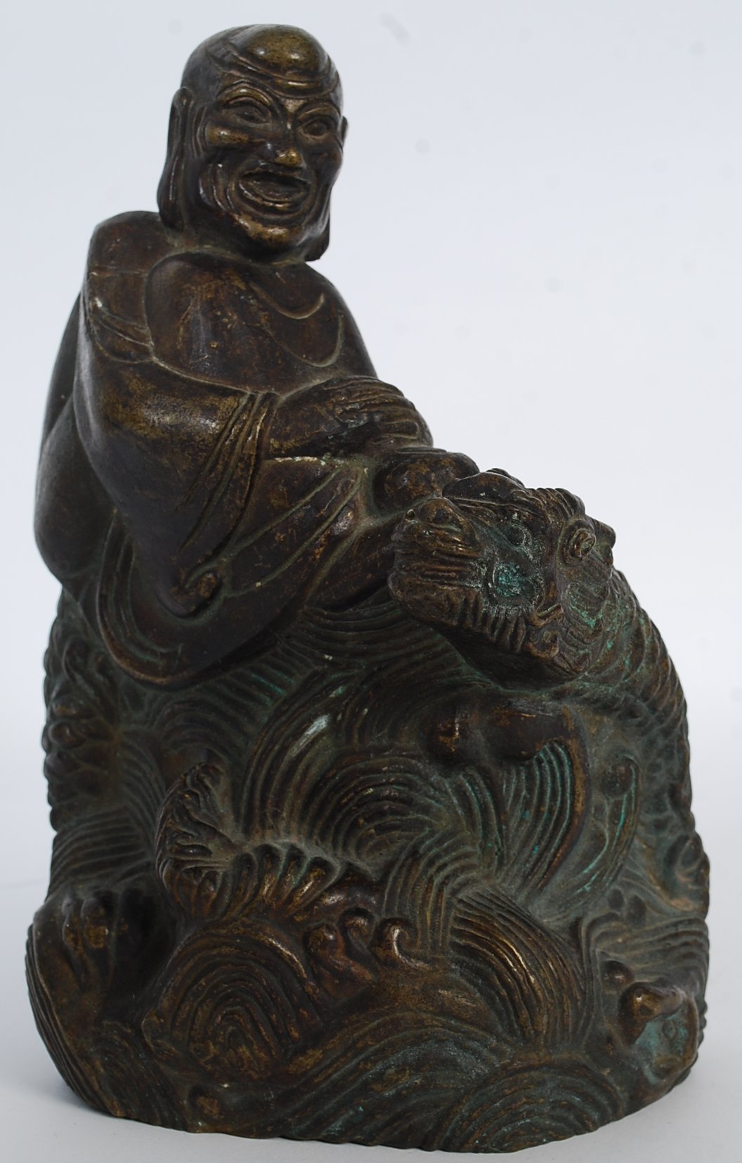 A 20th century hollow cast bronze statue of an oriental dragon. 22cm tall.