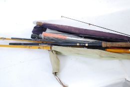 A large collection of vintage fishing rods to include an Abu Garcia rod, a sea fishing rod and a