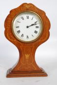 An Edwardian Arts & Crafts revival mahogany inlaid balloon clock. Tulip inlaid detail beneath the