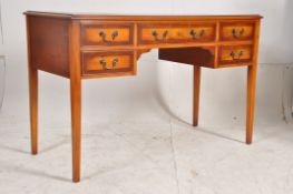 A Georgian style yew wood writing table desk. Square tapered legs with a series of drawers