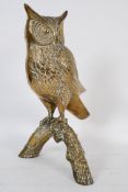 A 20th century decorative brass owl of large proportions perched atop of a branch.