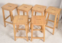 6 retro 1980's kitchen bar stools having square tops with legs united by stretchers. 74cms x 37cms x