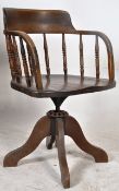 An Edwardian oak Industrial office desk swivel chair. Raised on shaped quadruped base with swivel