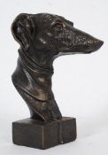 A metal artistic study of a greyhound racing dog on a plinth base. 21cm tall.