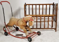An Edwardian mahogany childs dolls crib with decorative nursery ryhme to ends along with a plush toy