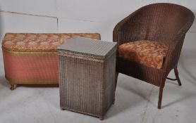 A Lloyd loom style bedroom armchair, ottoman and linen basket