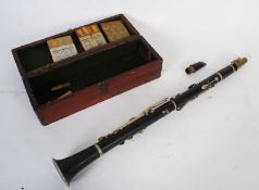A vintage cased Hawkes & Son clarinet instrument along with Boosey & Hawkes reeds and other