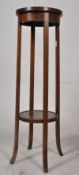 An Edwardian mahogany inlaid torchere / plant stand together with another of lower size.