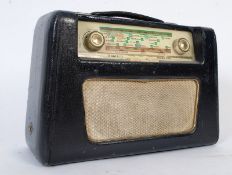 A vintage twin dial black leatherette covered Roberts radio on rotating base.