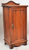 An Edwardian walnut pot / bedside cuboard. The plinth base with full length reeded door having